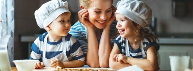 Happy mom and kids baking together