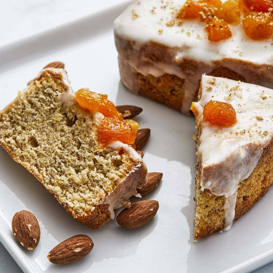 apricot gâteau nantais loaf topped with fruit and glaze sliced on a plate