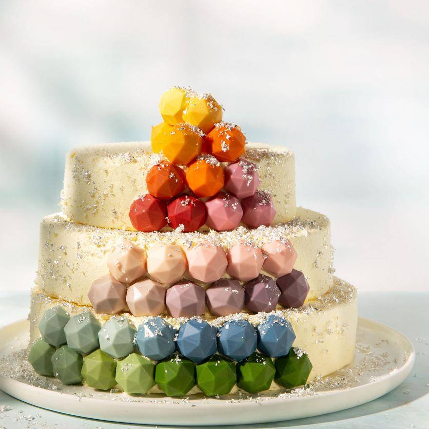 3-tiered birthday cake decorated with multicolored chocolate pralines