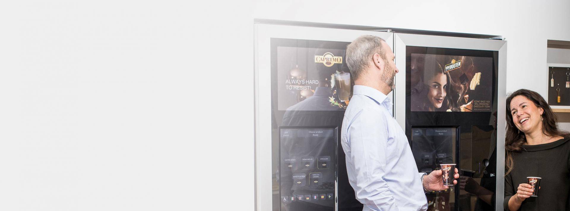 Man at vending machine with woman