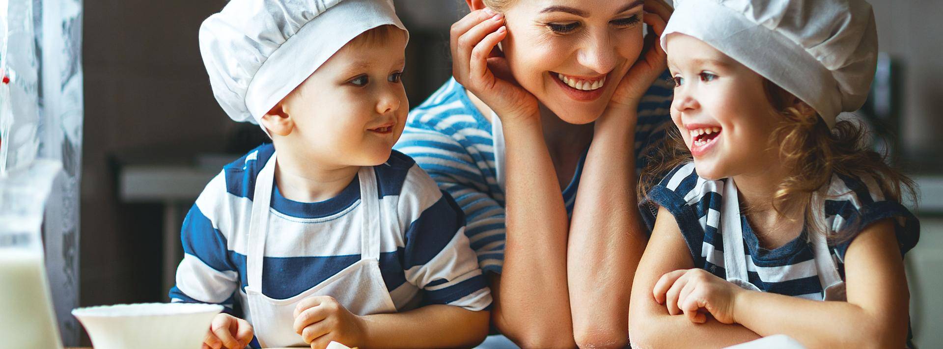 Happy mom and kids baking together