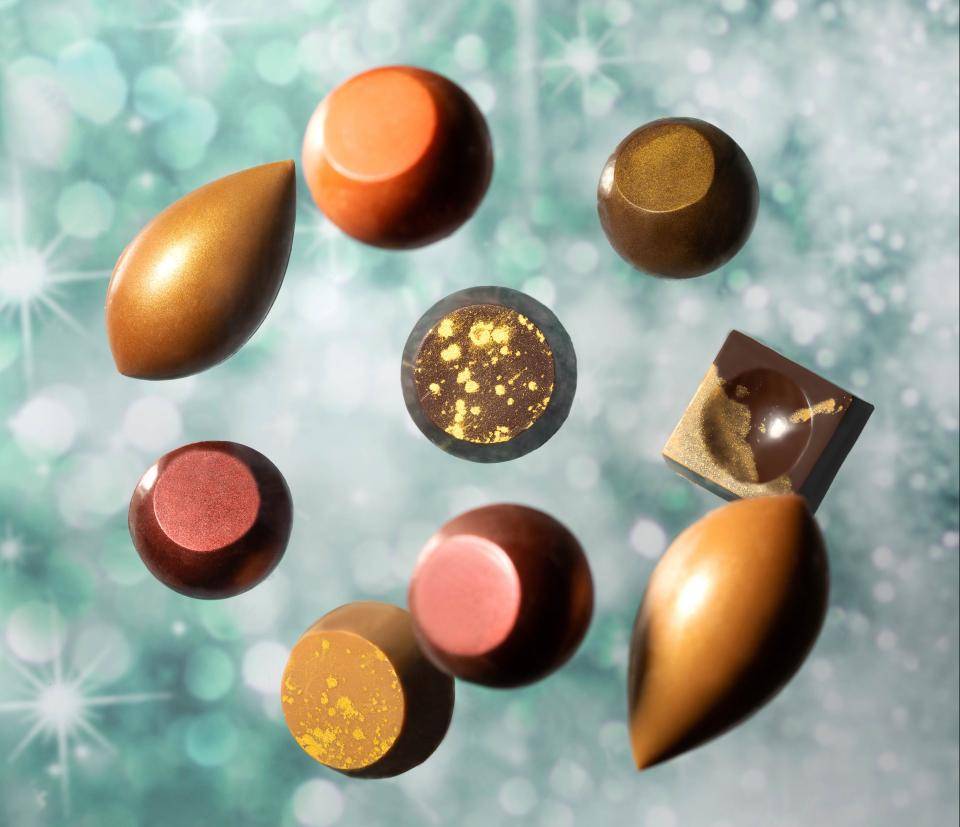 sparkling and shimmering colors, chocolate pralines, golden accents