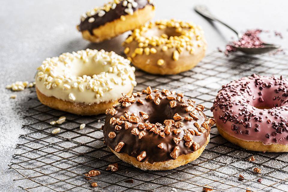 Chocolate-covered donuts with metallic chocolate sprinkles