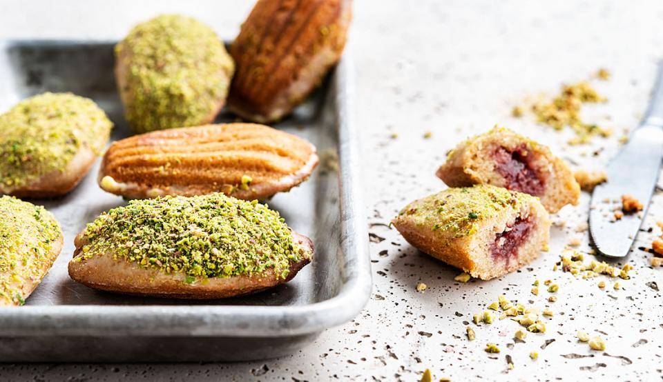 Vegan madeleines, made with raspberry filling and pistachio pieces