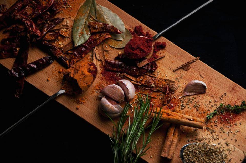 wooden board with seasonings on it