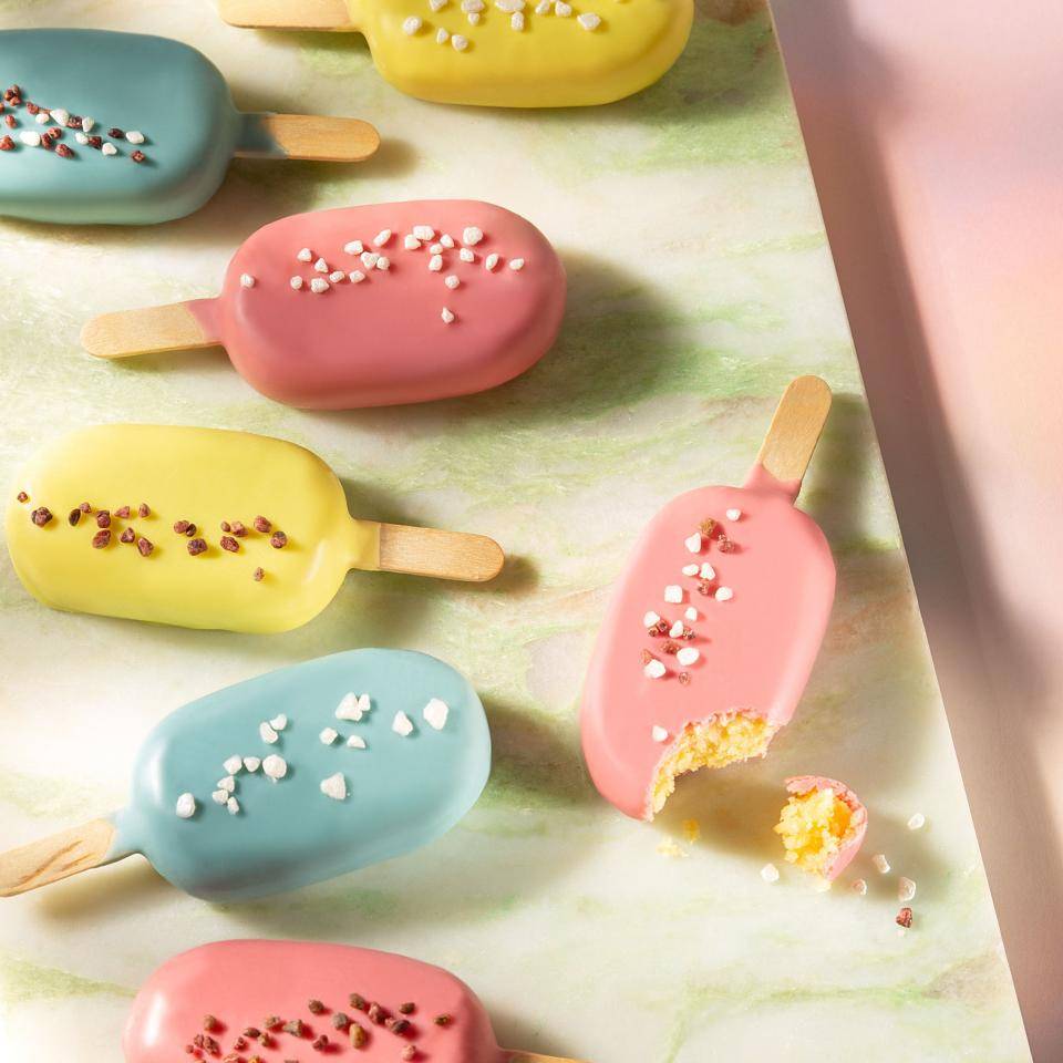 Cake pops dipped in colored chocolate and decorated with sprinkles