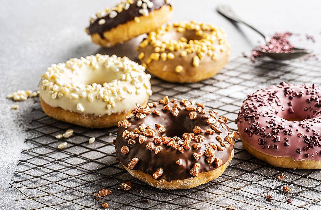 Chocolate-glazed donuts with metallic granella