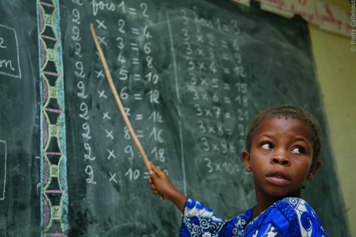 Child pointing at chalkboard