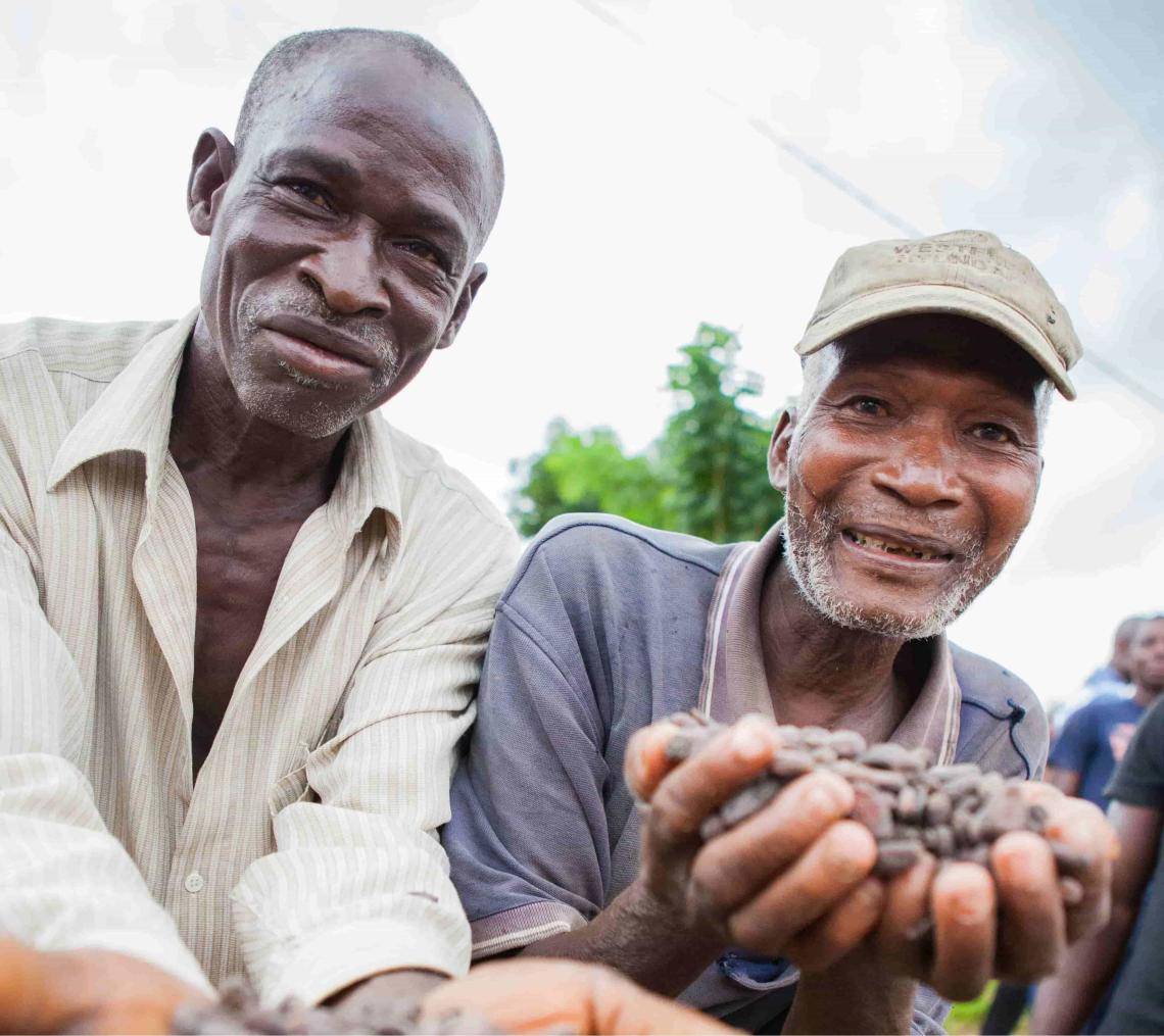 men holding cocoa beans