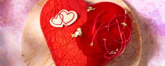 Heart shaped  pastry with red glaze and chocolate decoration